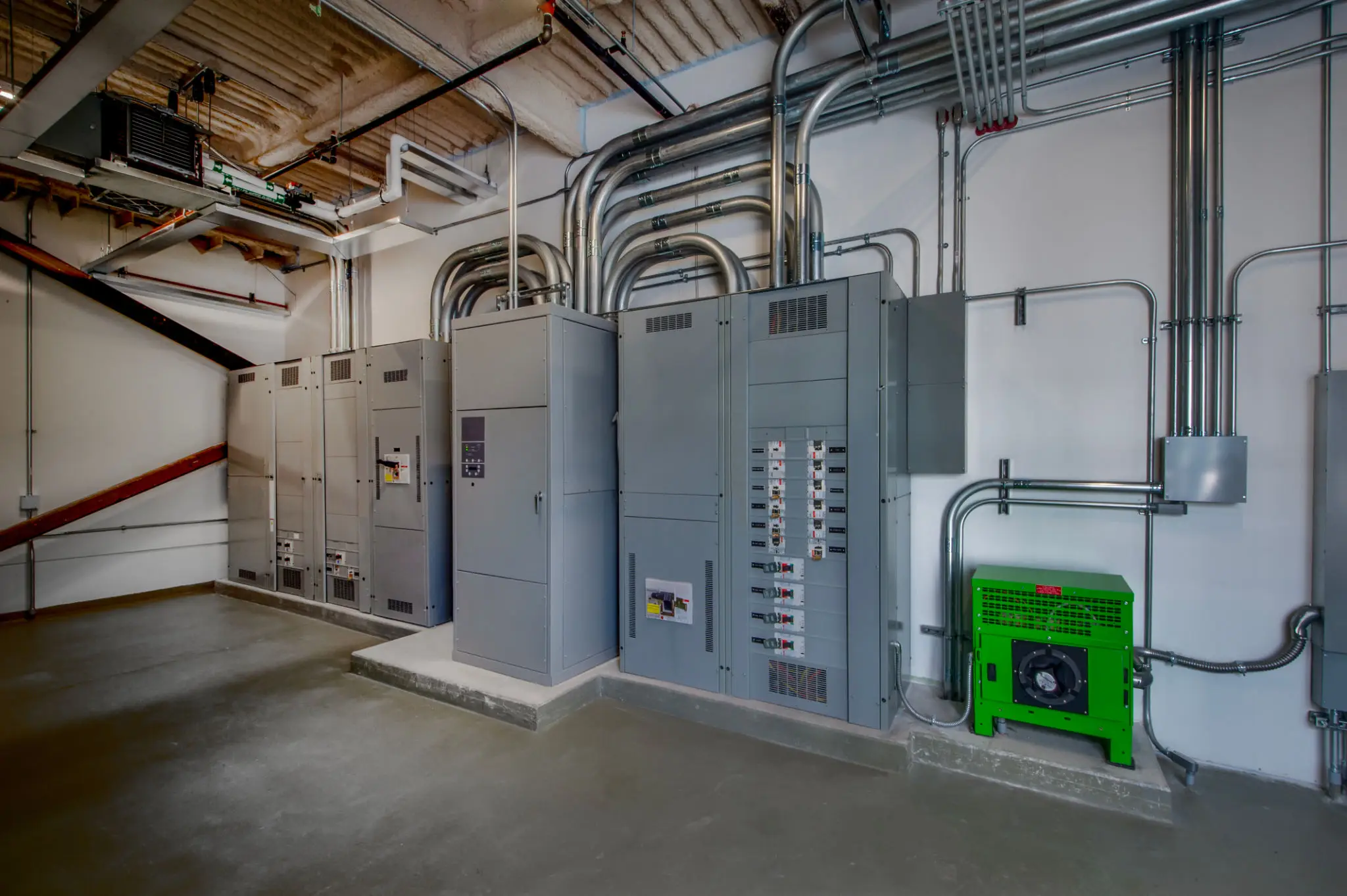 Electrical equipment and control panels in a commercial setting, showcasing organized wiring and HVAC components, relevant to Pendleton Electric's comprehensive electrical and HVAC services.